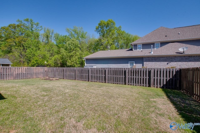 view of yard with a fenced backyard