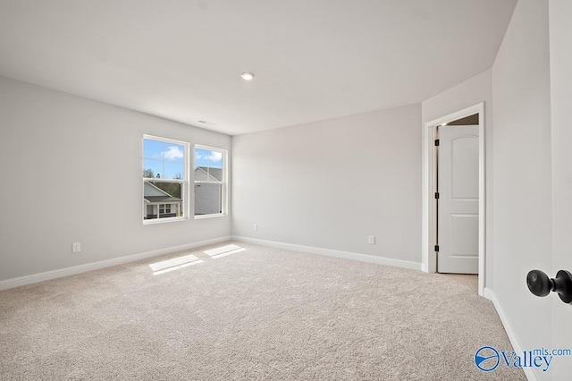 unfurnished room featuring recessed lighting, light colored carpet, and baseboards