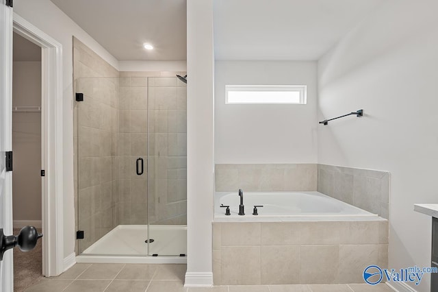 full bath featuring a stall shower, tile patterned flooring, and a bath