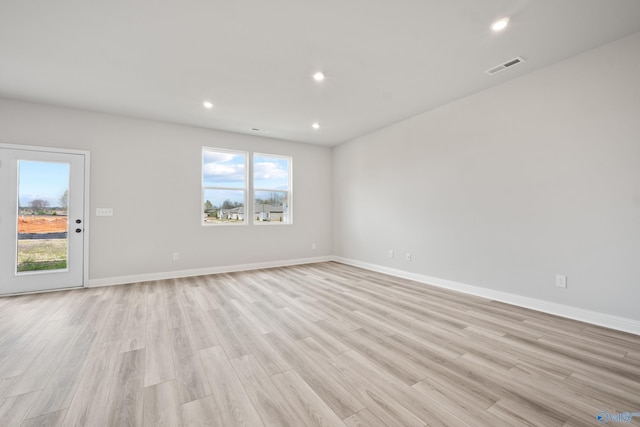 spare room featuring baseboards, visible vents, light wood-style flooring, and recessed lighting