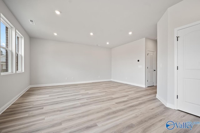 unfurnished room with recessed lighting, baseboards, visible vents, and light wood finished floors