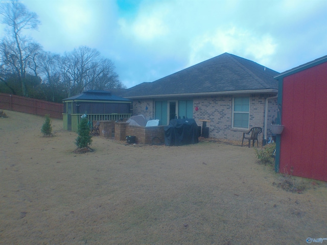 rear view of house with area for grilling