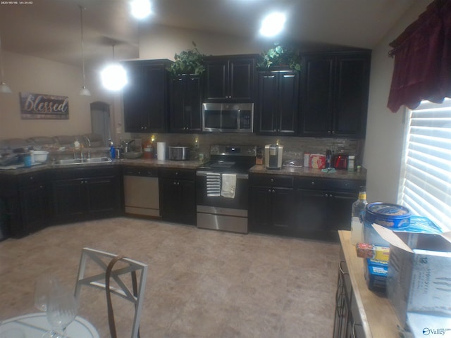 kitchen with backsplash, stainless steel appliances, and sink