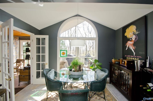 dining space featuring french doors and lofted ceiling