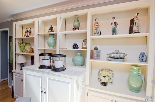 interior details featuring ornamental molding and wood finished floors