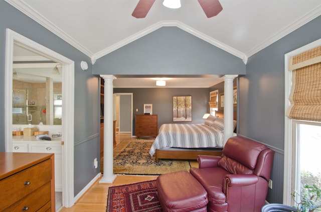 bedroom featuring decorative columns, ornamental molding, and vaulted ceiling