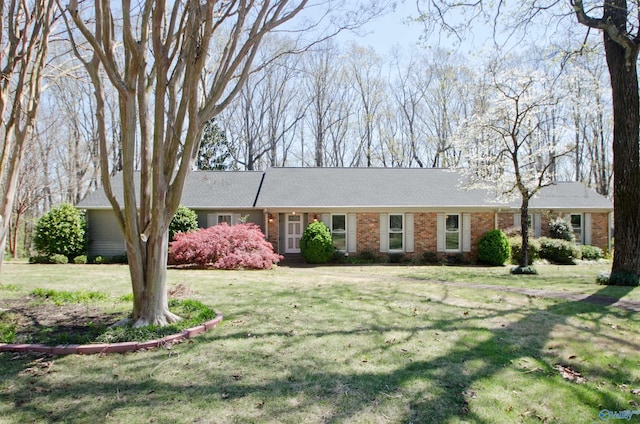 ranch-style house with brick siding and a front lawn