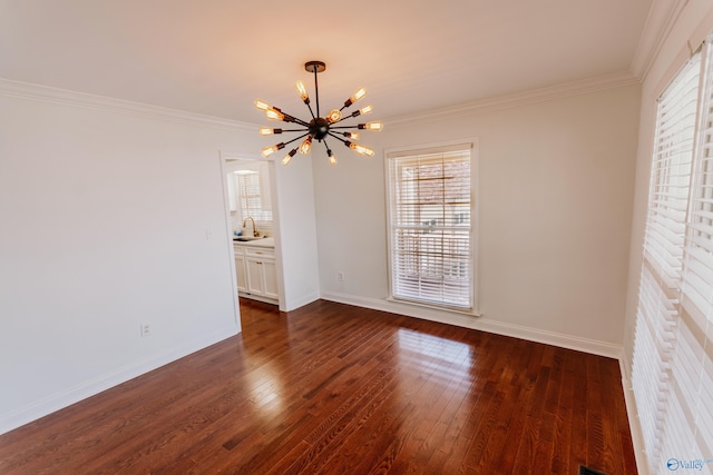 unfurnished room featuring dark hardwood / wood-style flooring, sink, crown molding, and a chandelier