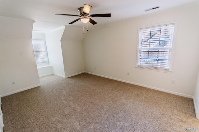 additional living space with light carpet and ceiling fan