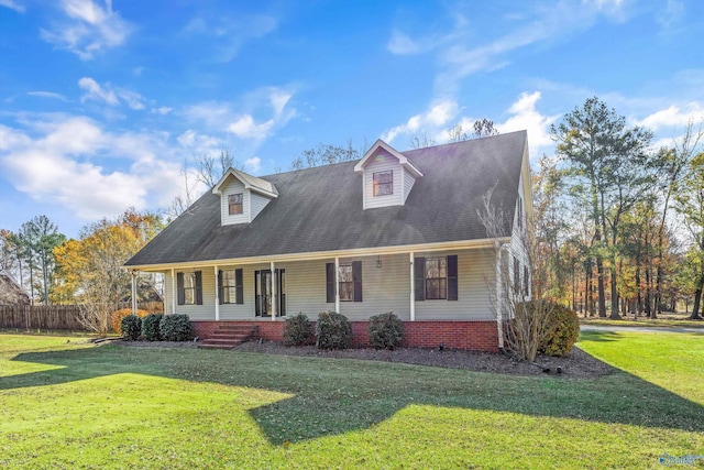 new england style home featuring covered porch and a front yard