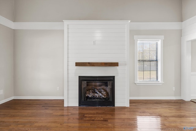 unfurnished living room with a fireplace and dark hardwood / wood-style floors