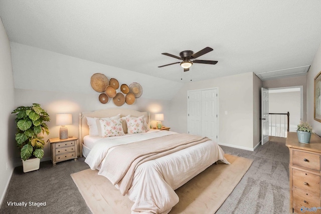 bedroom with ceiling fan, a closet, dark carpet, and a textured ceiling