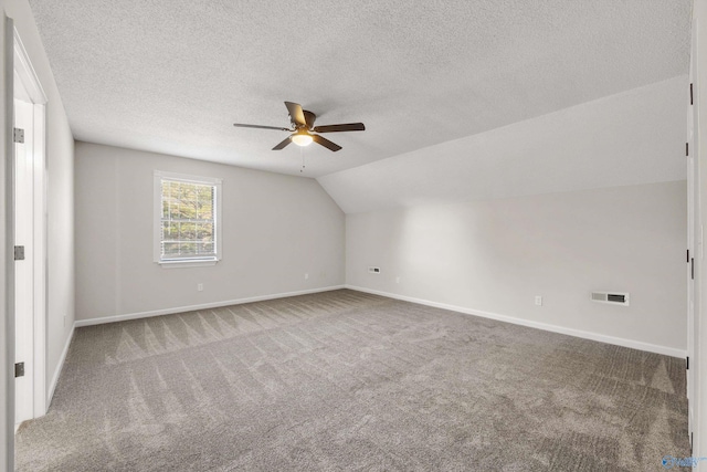 bonus room with carpet, ceiling fan, lofted ceiling, and a textured ceiling
