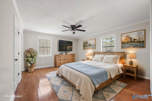 bedroom with hardwood / wood-style floors, ceiling fan, and ornamental molding