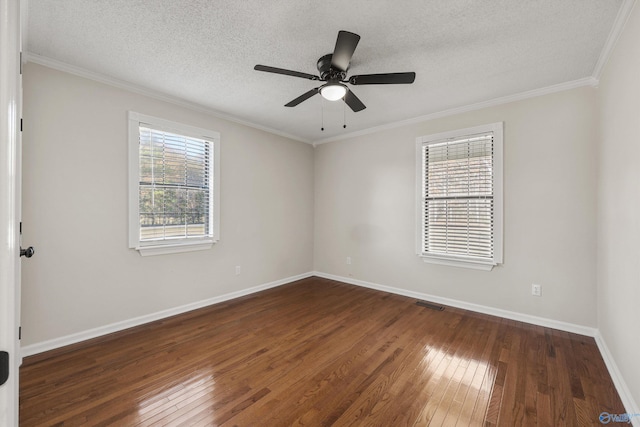 unfurnished room featuring dark hardwood / wood-style floors, a healthy amount of sunlight, ornamental molding, and a textured ceiling
