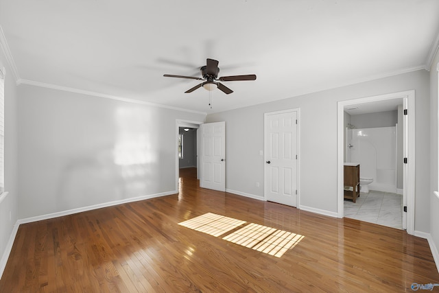 unfurnished bedroom with connected bathroom, ceiling fan, light hardwood / wood-style flooring, crown molding, and a closet