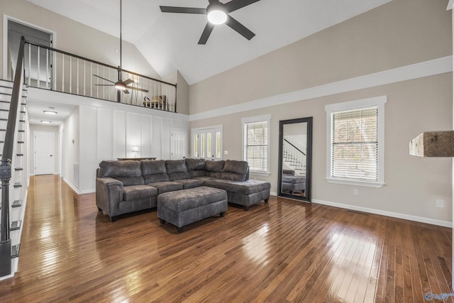 living room with high vaulted ceiling, ceiling fan, and dark wood-type flooring