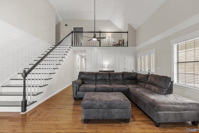 living room with hardwood / wood-style floors, high vaulted ceiling, and ceiling fan