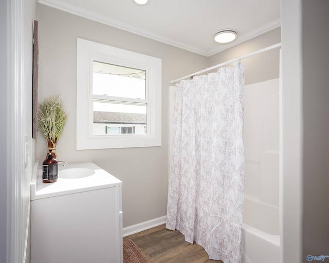 bathroom featuring wood-type flooring, vanity, ornamental molding, and shower / bath combo