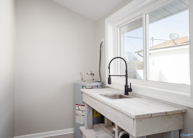 bathroom featuring sink and water heater