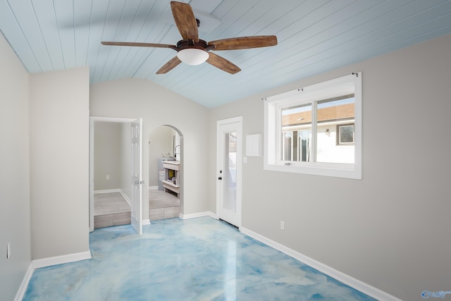 empty room with ceiling fan, wood ceiling, and vaulted ceiling