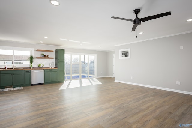 unfurnished living room with ceiling fan, ornamental molding, hardwood / wood-style floors, and sink