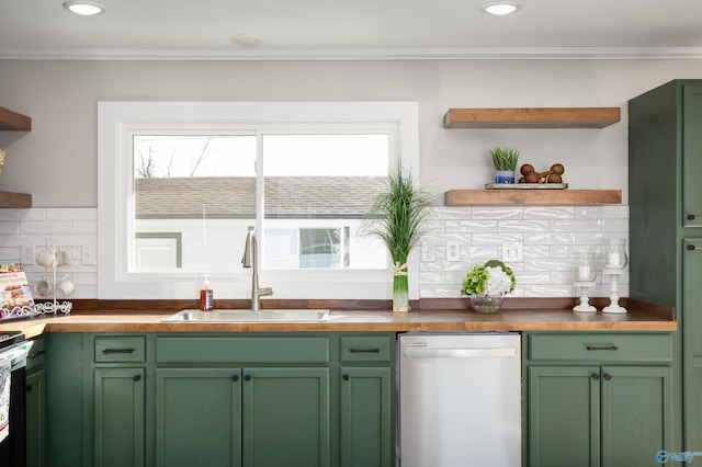 kitchen with dishwasher, tasteful backsplash, sink, ornamental molding, and green cabinets