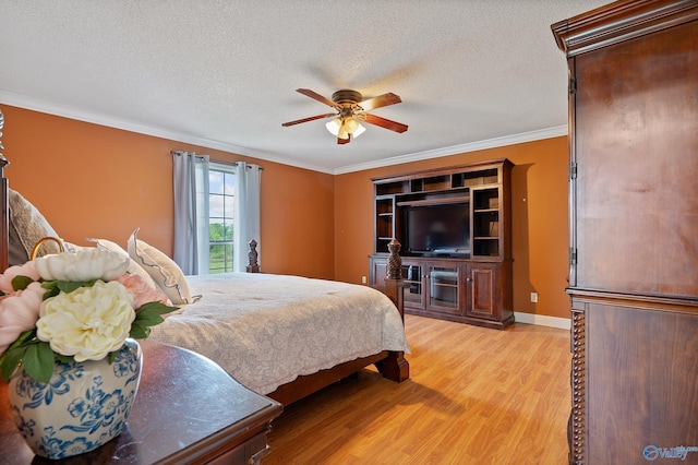 bedroom with ornamental molding, baseboards, ceiling fan, light wood-type flooring, and a textured ceiling