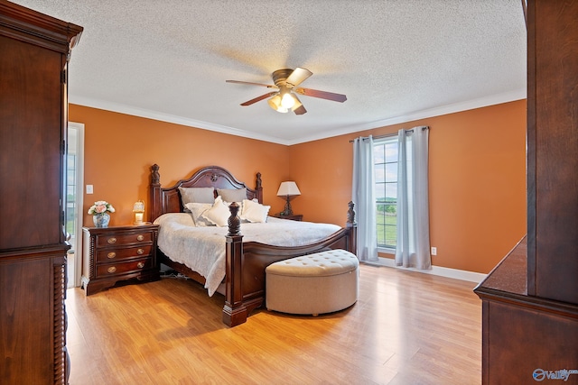 bedroom featuring crown molding, a textured ceiling, and light wood-style flooring