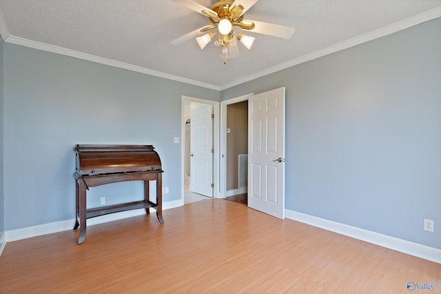 bedroom featuring crown molding, baseboards, ceiling fan, and wood finished floors