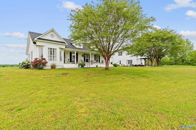 rear view of house with a porch and a yard