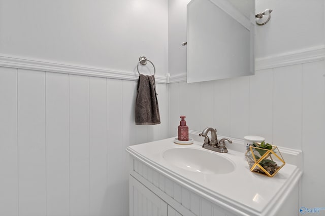 bathroom with vanity and a decorative wall