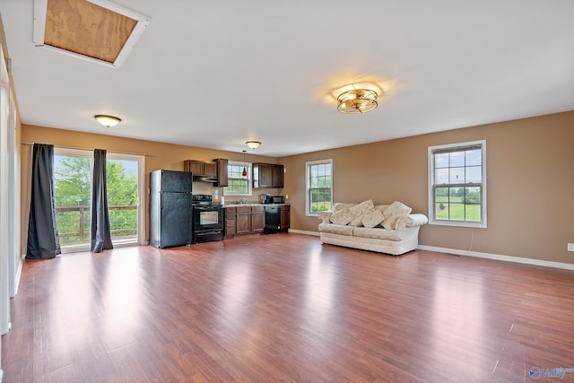 living area featuring baseboards and dark wood finished floors