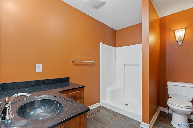 full bath with visible vents, vanity, a shower, toilet, and baseboards