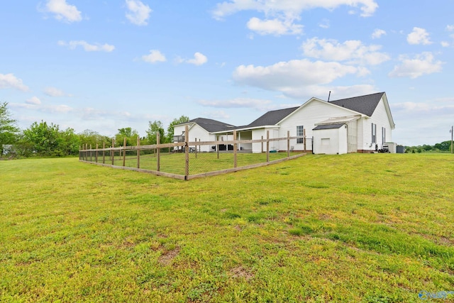view of yard with fence and a garage
