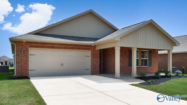 view of front of home featuring a garage, concrete driveway, brick siding, and a front lawn