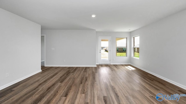 unfurnished room featuring dark hardwood / wood-style flooring