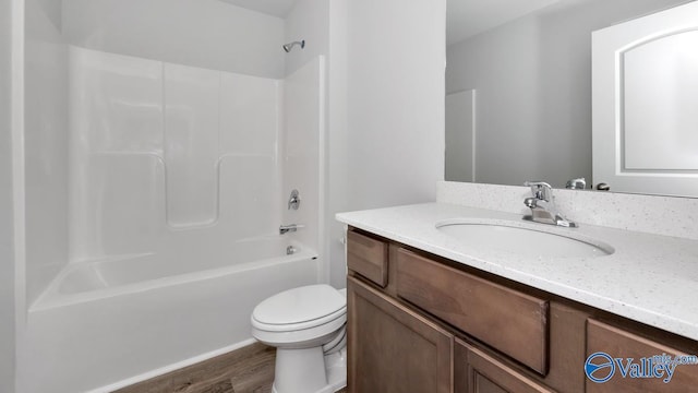 full bathroom with vanity, hardwood / wood-style flooring, tub / shower combination, and toilet