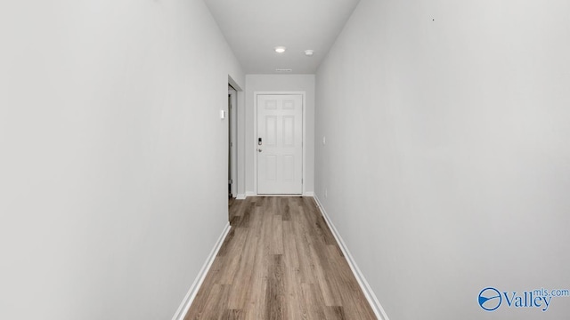 corridor with light wood-type flooring