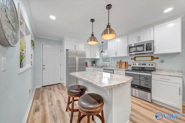 kitchen with visible vents, baseboards, stainless steel appliances, light wood-style floors, and white cabinetry