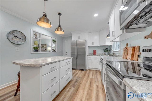 kitchen with a sink, stainless steel appliances, ornamental molding, and a center island