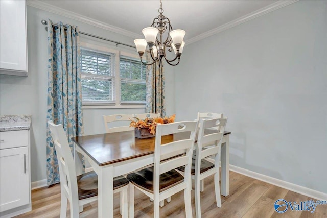 dining space featuring light wood-style floors, baseboards, a chandelier, and ornamental molding