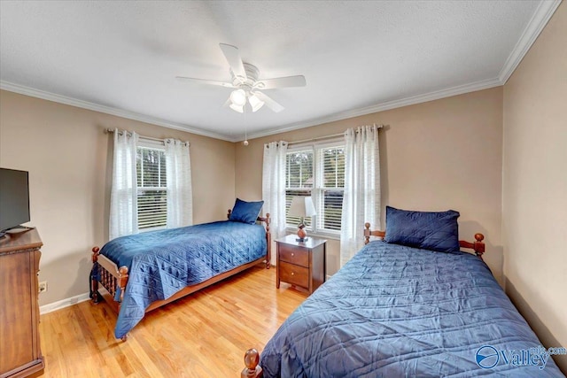 bedroom with light wood-style flooring, multiple windows, baseboards, and ornamental molding