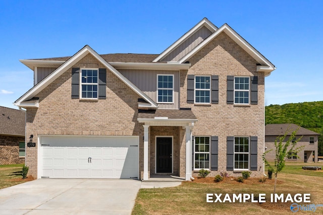 view of front of property with board and batten siding, concrete driveway, brick siding, and a garage