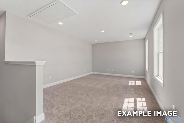 empty room featuring attic access, recessed lighting, carpet floors, and baseboards