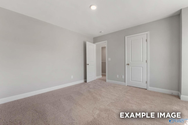 unfurnished bedroom with carpet floors and baseboards