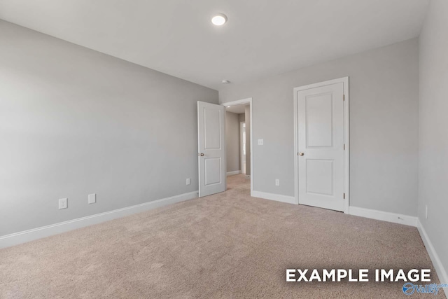 unfurnished bedroom with carpet floors and baseboards