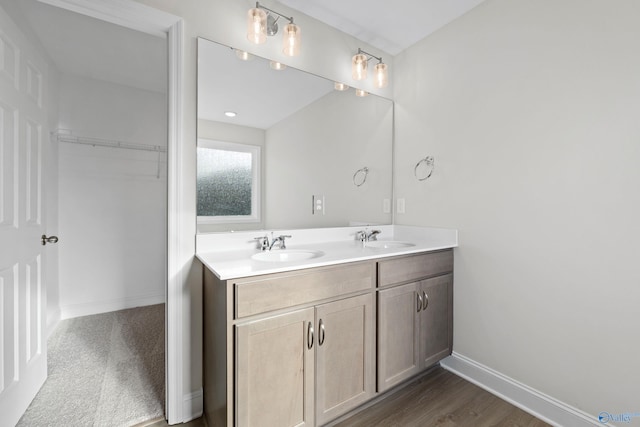 2159 Dawson Ln NE, Cullman, AL 35058 - bathroom with a sink, baseboards, double vanity, and a walk in closet