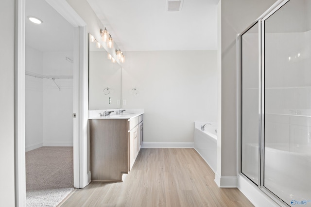 2159 Dawson Ln NE, Cullman, AL 35058 - full bathroom featuring visible vents, a shower stall, wood finished floors, vanity, and baseboards