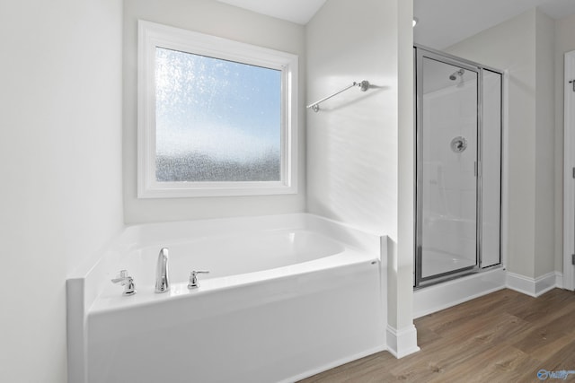 2159 Dawson Ln NE, Cullman, AL 35058 - full bathroom with a garden tub, baseboards, a stall shower, and wood finished floors